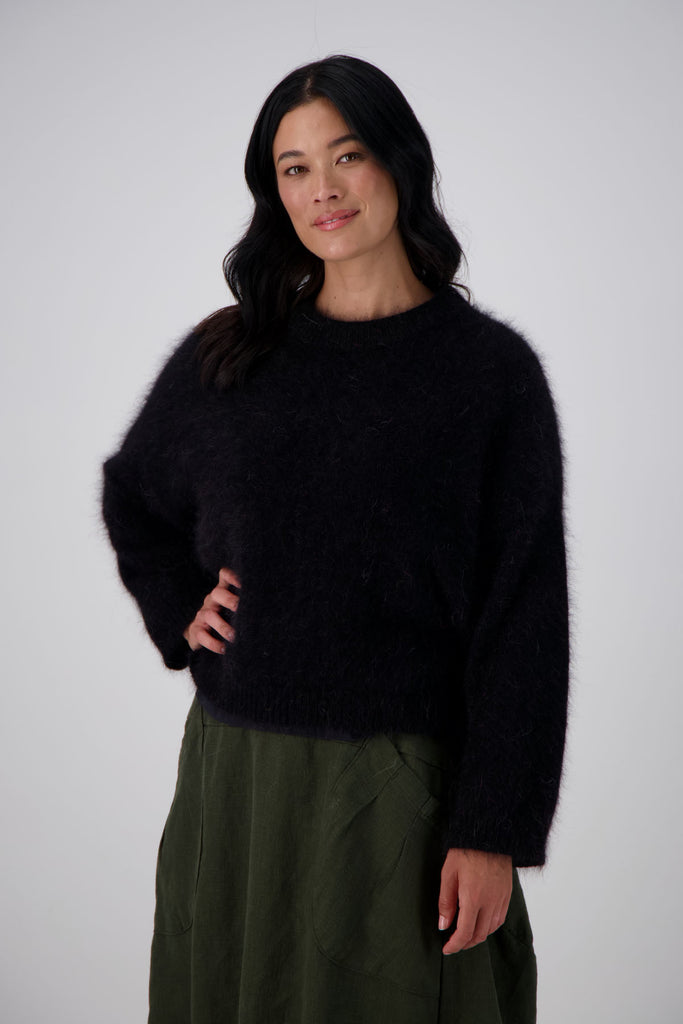 Olga de Polga Montreal Angora Sweater in Black. Our Montreal Angora knits take cosy to a new level. The knit features a ribbed round neckline, drop shoulder and cropped length, so it is perfect with jeans and skirts. The fit is slightly oversized with a boxy cut and long sleeves.