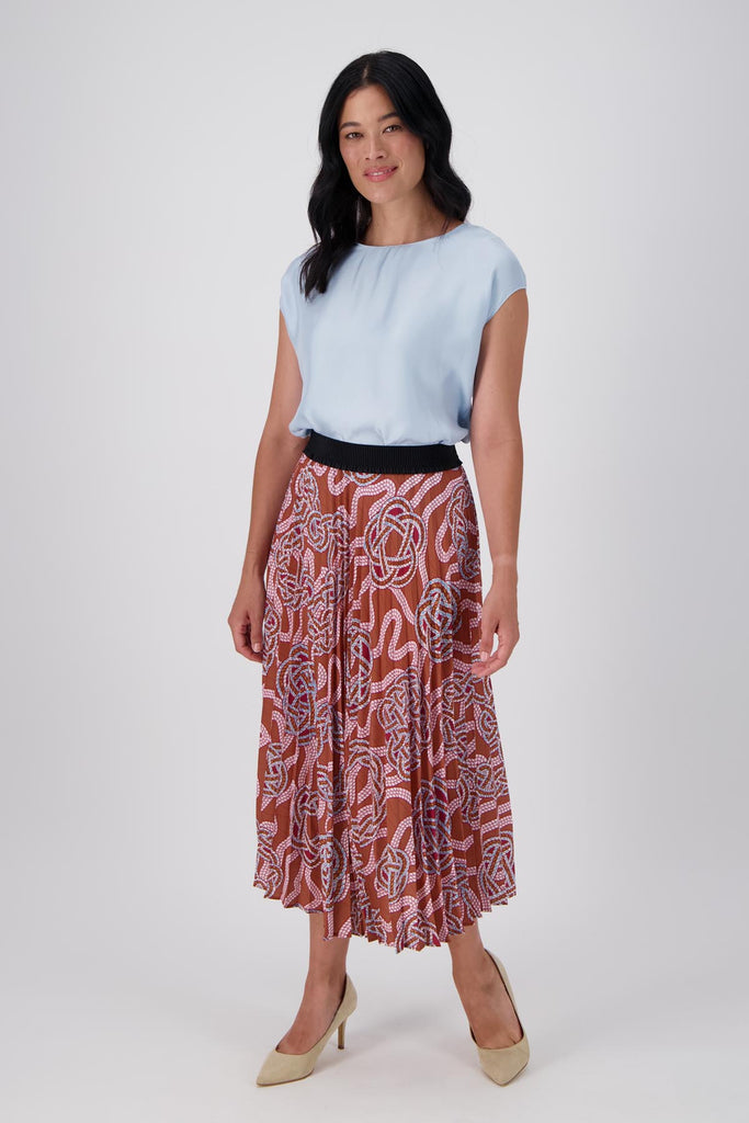 Olga de Polga Loveknots print pleated skirt. Midi length skirt with a black elasticated waistband. Front full length view on model