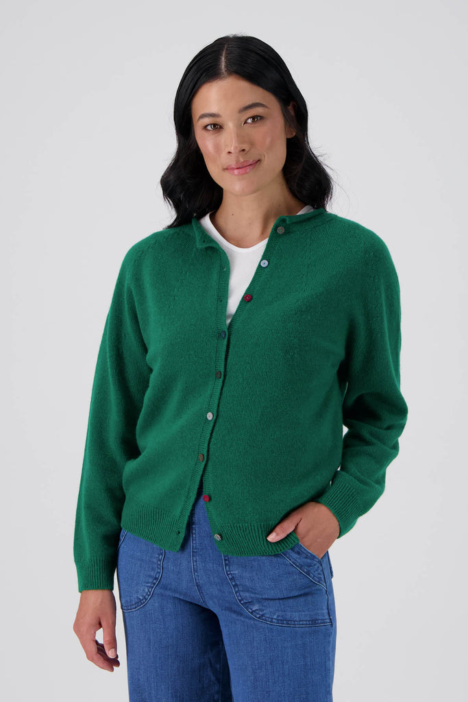 Green Olga de Polga Kyoto cardigan in a wool cashmere blend. With a round neckline and long sleeves, this cardigan has a button down front with small unique buttons. Front view on model.