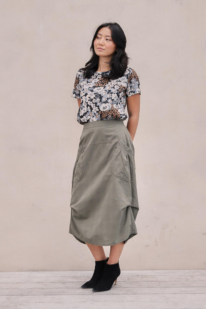 Olga de Polga Milwaukee skirt in Khaki Textured cotton. Mid-weight slightly textured cotton with a fine check pattern and heavy drape. Side front view on model