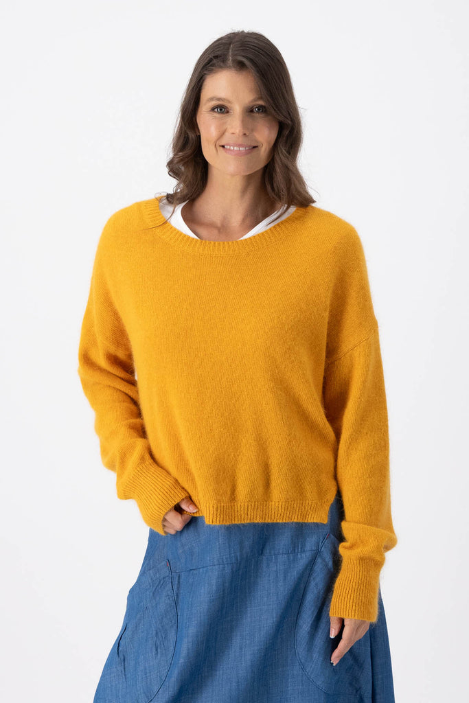 Olga de Polga Mustard Portland sweater in an angora/wool fabrication. With a round neck and slightly cropped length, the sweater has long sleeves. Front view