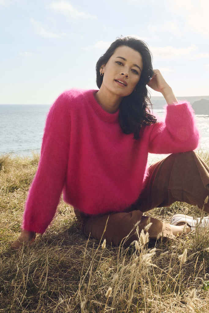 Olga de Polga's Neon Pink angora sweater knit jumper.  Crafted in an impossibly soft angora blend, this jumper will keep you warm on the greyest of days while still staying comfortable and light. Front view