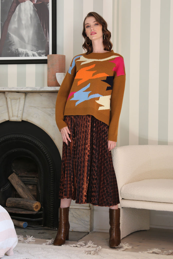 woman in caramel knit sweater and disco skirt