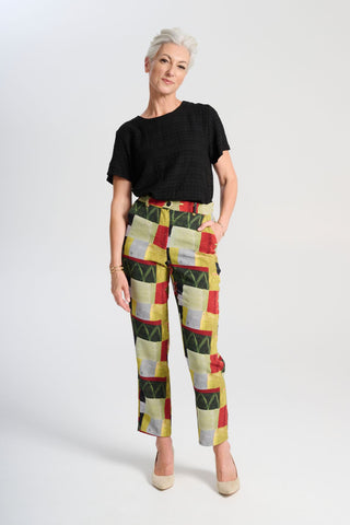 Olga de Polga green printed Pantalon pants in Kismet Sage. The Pantalon is a straight-legged pant that reaches the lower ankle, featuring a button and zip closure at the front with an elasticised back waistband for added comfort.  Front view on model