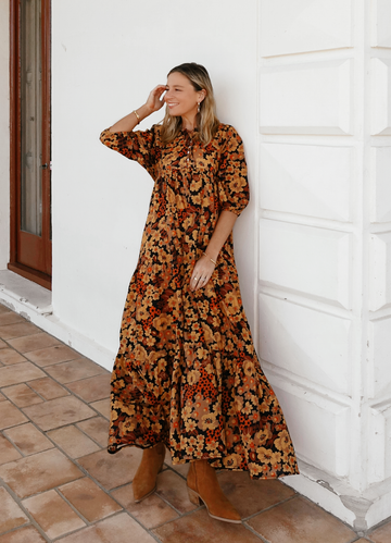 hobo maxi dress in oranges and browns printed fabric. Button front and neckline tie.