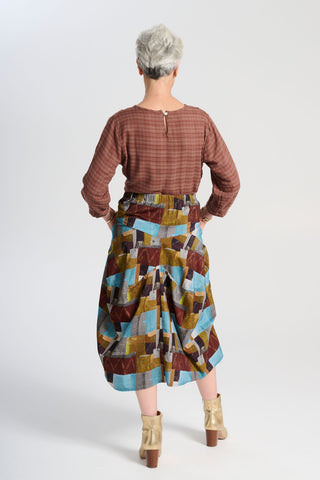 Olga de Polga blue Azure Kismet printed Milwaukee skirt in fine cord. Our best selling incredibly unique, chic and original skirt. It is universally flattering, highly versatile, and super comfortable. Perfect to throw on and go. Back view on model