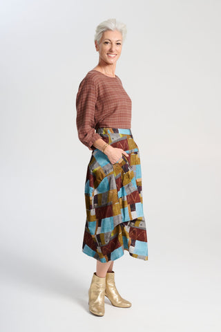 Olga de Polga blue Azure Kismet printed Milwaukee skirt in fine cord. Our best selling incredibly unique, chic and original skirt. It is universally flattering, highly versatile, and super comfortable. Perfect to throw on and go. Side view on model