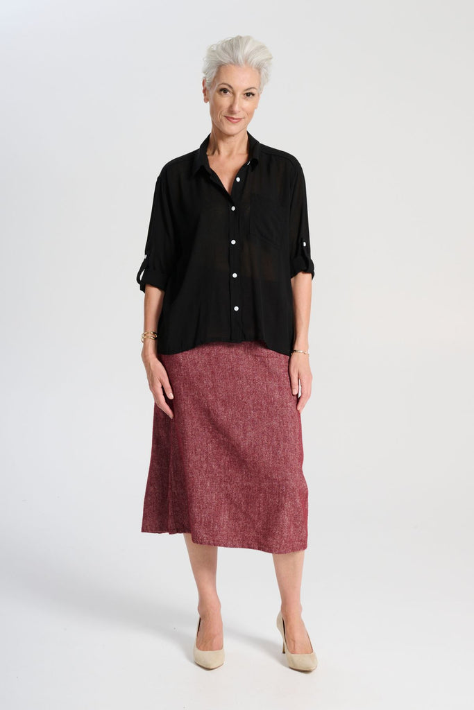 Olga de Polga Ava blouse in Black soft viscose crepe. Front button opening, shirt collar, adjustable sleeve length. Front patch pocket. Front view on model