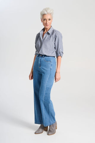 Olga de Polga striped Indra shirt in Licorice. The signature Olga Shirt is great for all occasions. It has an effortlessly chic, relaxed silhouette that drapes with ease. Leave it loose or tuck it in - the choice is yours. Side view on model.