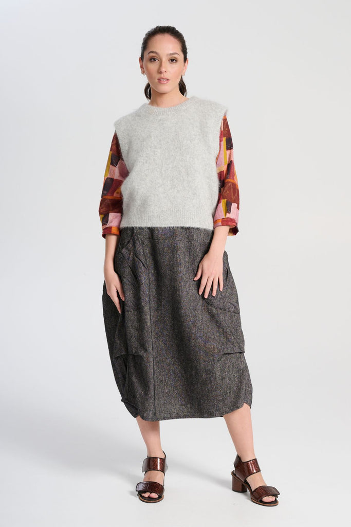 Olga de Polga Milwaukee Haven skirt in black licorice linen. Large front patch pockets, back elasticated waistband. Flat front waistband. Front view worn with a knit vest in light grey.