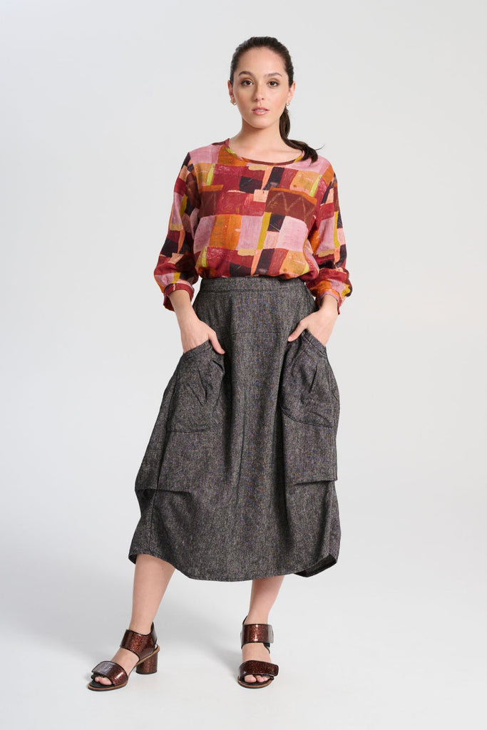 Olga de Polga Milwaukee Haven skirt in black licorice linen. Large front patch pockets, back elasticated waistband. Flat front waistband. Front view on model.