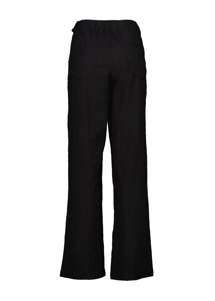 Olga de Polga Peggy Pants Long Lino in Black linen. Featuring a flattering high waist with an elasticated back, these pants provide all-day comfort while maintaining a sleek, streamlined look. With their stretchy wide-leg fit, flat front, and full-length silhouette, they effortlessly elevate any outfit. Back view.