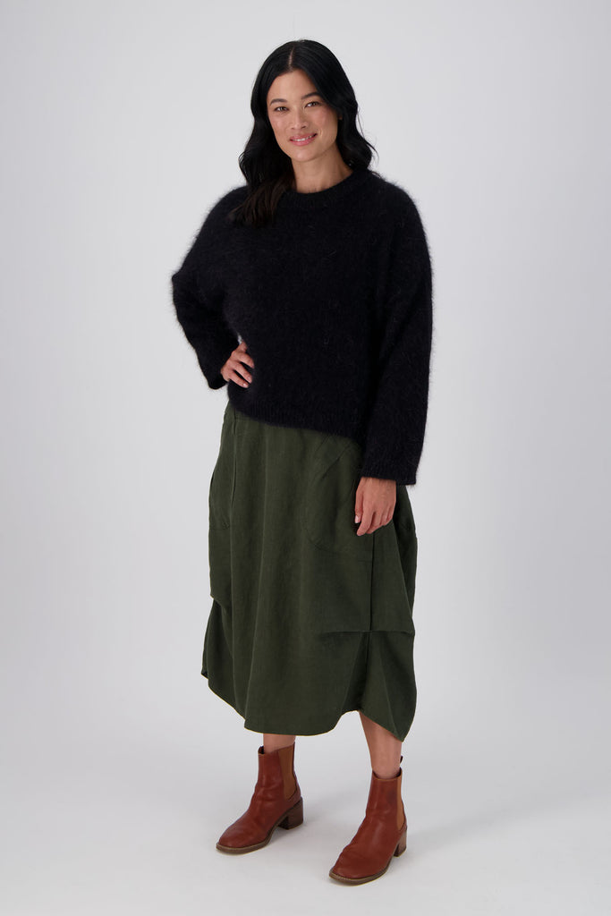 Olga de Polga Montreal Angora Sweater in Black. Our Montreal Angora knits take cosy to a new level. The knit features a ribbed round neckline, drop shoulder and cropped length, so it is perfect with jeans and skirts. The fit is slightly oversized with a boxy cut and long sleeves.