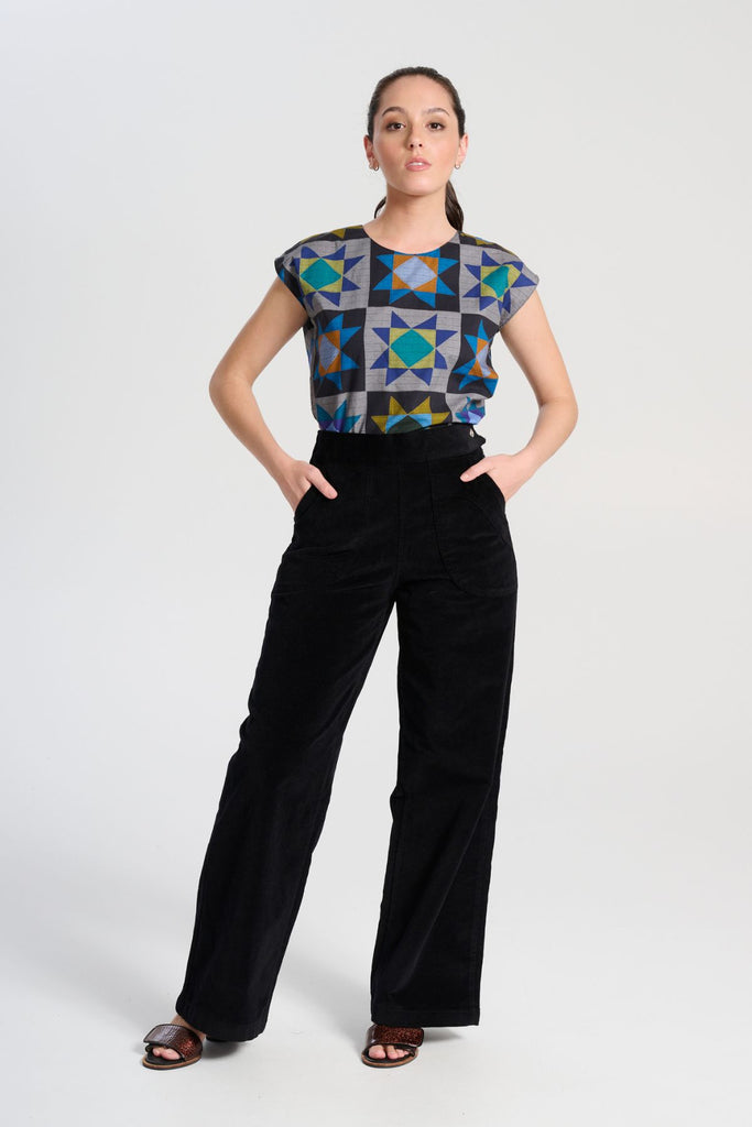 Olga de Polga Peggy Paris long pants in soft black cotton velvet. Soft to the touch yet durable, the fabric drapes beautifully while maintaining its shape, making these pants ideal for cooler months. Full length front view
