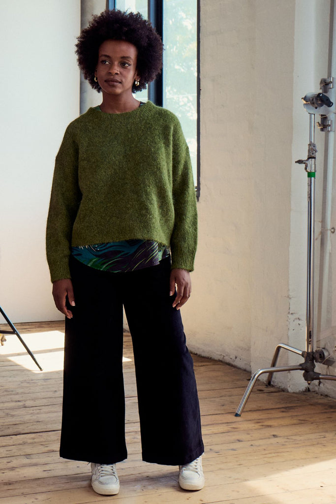 Olga de Polga Black Peggy Sue pants in cotton velvet corduroy. Comfortable high waist. Elastic waistband at the back. Front full view on model