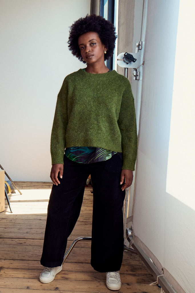 Olga de Polga Black Peggy Sue pants in cotton velvet corduroy. Comfortable high waist. Elastic waistband at the back. Front view on model.