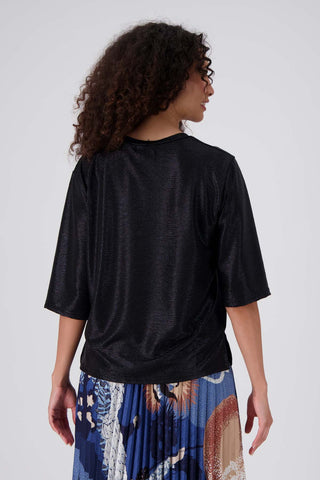 Olga de Polga Black Prosecco top in metallic polyester fabric. With a relaxed fit, scoop neckline, and 3/4 length sleeves, your everyday t-shirt now boasts a lustrous twist. Back view on model.