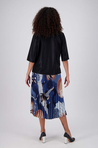 Olga de Polga Black Prosecco top in metallic polyester fabric. With a relaxed fit, scoop neckline, and 3/4 length sleeves, your everyday t-shirt now boasts a lustrous twist.  Back full length view on model