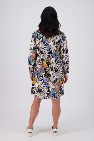 Olga de Polga tunic dress in Wildflowers printed cotton corduroy. Long sleeves with a cuff and a front button opening. Back view on model.