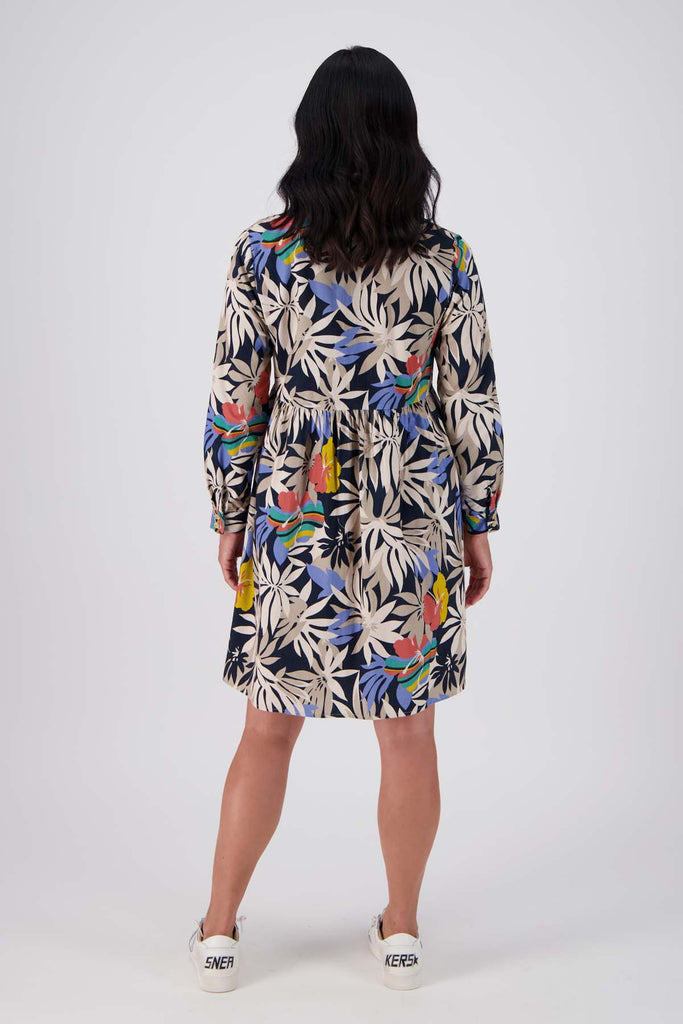 Olga de Polga tunic dress in Wildflowers printed cotton corduroy. Long sleeves with a cuff and a front button opening. Back view on model.