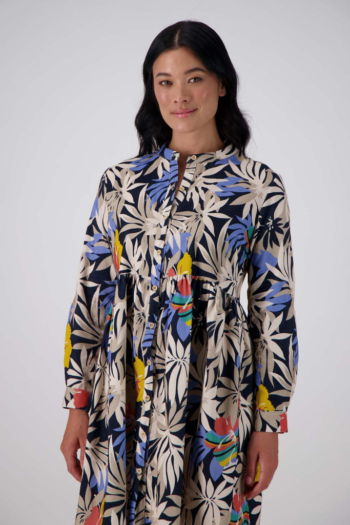 Olga de Polga tunic dress in Wildflowers printed cotton corduroy. Long sleeves with a cuff and a front button opening. Front view on model