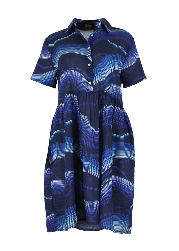 Olga de Polga villa drop waist dress in Blue Aurora printed cotton seersucker fabric. A shirt dress with a collar and buttons down to the waist. Short Sleeves. Gathering on the skirt from below the waist seam. Front view