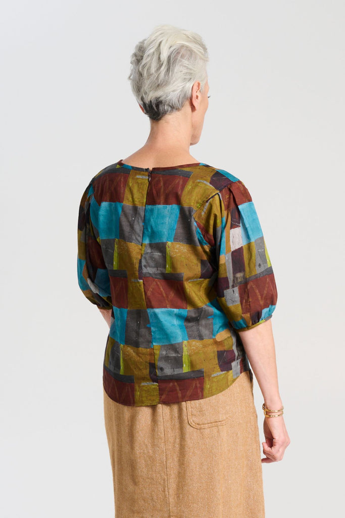 Olga de Polga blouse in the Azure Kismet print from our AW25 Odyssey collection. Round neckline, half sleeves, back zip fastening.  Back view on model