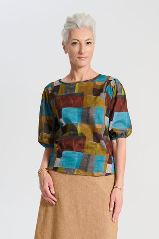 Olga de Polga blouse in the Azure Kismet print from our AW25 Odyssey collection. Round neckline, half sleeves, back zip fastening. Front view on model.