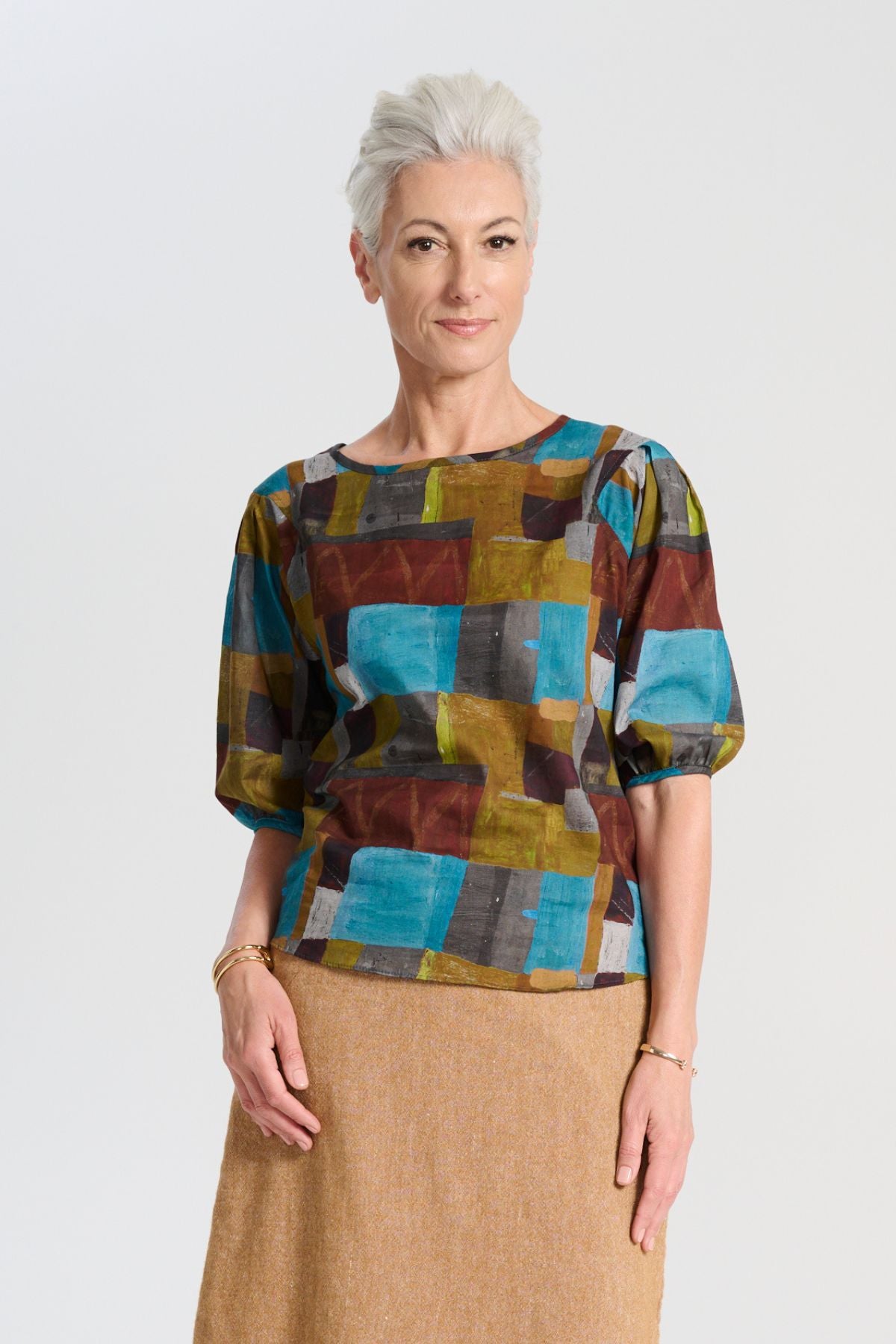 Olga de Polga blouse in the Azure Kismet print from our AW25 Odyssey collection. Round neckline, half sleeves, back zip fastening. Front view on model.