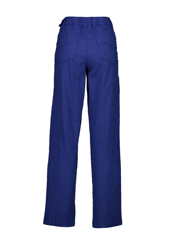 Olga de Polga Peggy Pants Long Lino in Cobalt Blue linen. Featuring a flattering high waist with an elasticated back, these pants provide all-day comfort while maintaining a sleek, streamlined look. With their stretchy wide-leg fit, flat front, and full-length silhouette, they effortlessly elevate any outfit. Back view.