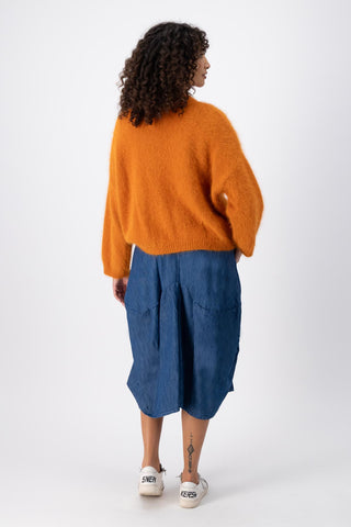 Our new Milwaukee Denim skirt is here! Cut in a universally-flattering a-line design, the pockets and subtle gathers on this skirt create a unique shape. Available in two shades of blue denim. Back view
