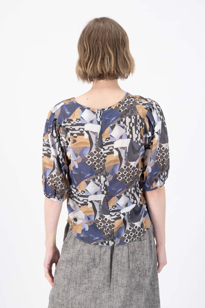 Olga de Polga Mezclar printed cotton seersucker blouse. The blouse features a beautifully detailed lantern sleeve with a drop shoulder and delicate pleating on the shoulder and cuff. It also has a wide boat neckline and invisible zip fastening at the back. Back view on model