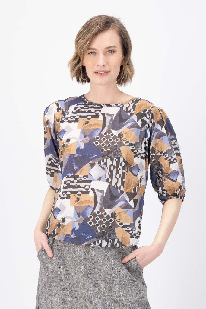 Olga de Polga Mezclar printed cotton seersucker blouse. The blouse features a beautifully detailed lantern sleeve with a drop shoulder and delicate pleating on the shoulder and cuff. It also has a wide boat neckline and invisible zip fastening at the back. Front close view on model