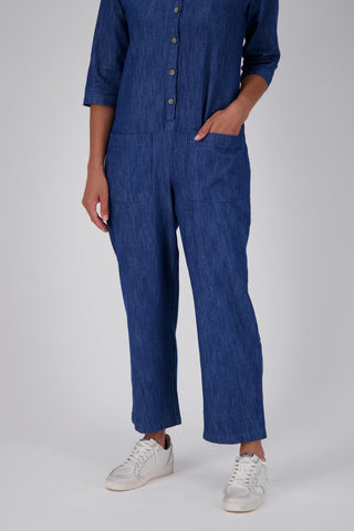 Olga de Polga Blue mid-wash denim Artisan Jumpsuit in cotton denim. Half sleeves and a button down front with patch pockets. Ankle length.  Front leg detail photo