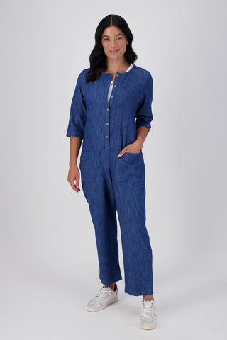Olga de Polga Blue mid-wash denim Artisan Jumpsuit in cotton denim. Half sleeves and a button down front with patch pockets. Ankle length.  Front full view on model