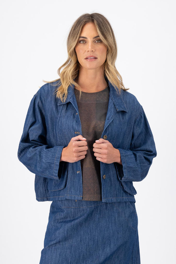 Olga de Polga Mid-Wash denim Billie jacket. Front patch pockets. Oversized boxy fit. Button down front. Full length sleeves. Front  close-up view on model.