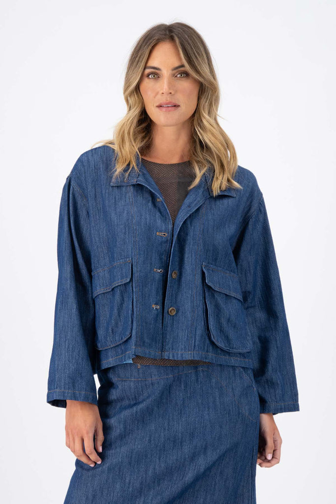 Olga de Polga Mid-Wash denim Billie jacket. Front patch pockets. Oversized boxy fit. Button down front. Full length sleeves. Front view on model.