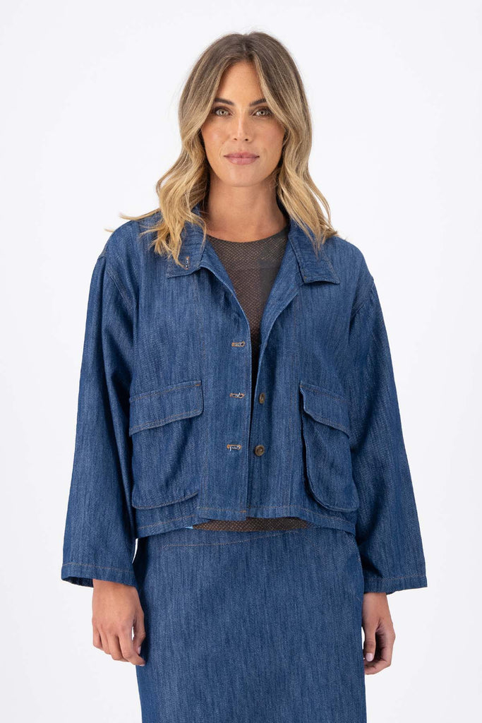 Olga de Polga Mid-Wash denim Billie jacket. Front patch pockets. Oversized boxy fit. Button down front. Full length sleeves. Front view on model.