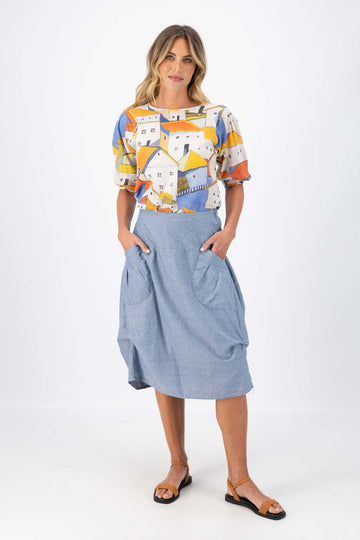 Olga de Polga Milwaukee Traveller skirt in Sky Blue cotton, linen, Tencel blend. The Milwaukee is an incredibly unique, chic and original skirt. It is universally flattering, highly versatile, and super comfortable. Perfect to throw on and go. Front view on model.