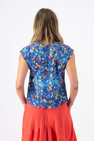 Olga de Polga classic tee top in Blue printed cotton. Print name: Spacio. Blue with accents of red, orange and yellow. Space inspired. Back view on model