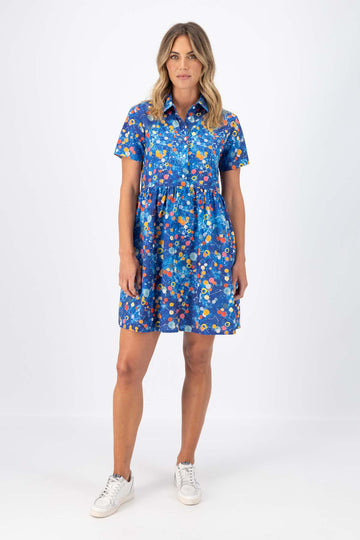 Olga de Polga blue Spacio printed 100% cotton dress. Villa dress with a collar and button down front. Gathering at the waist and finishes above the knee depending on your height. Front view on model.