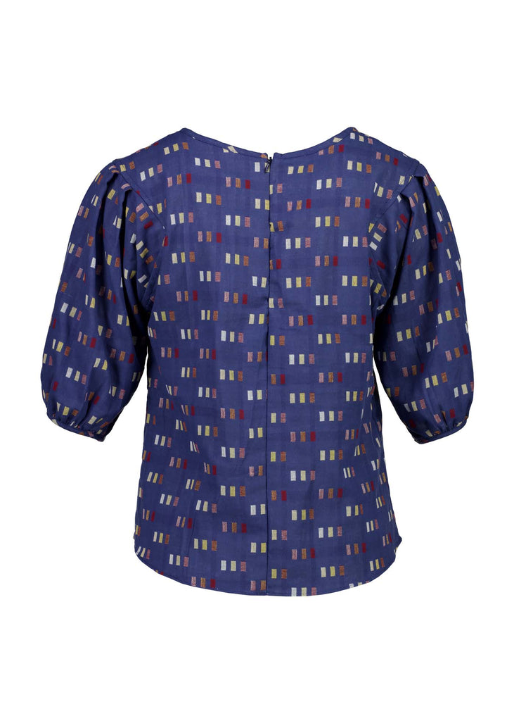 Our signature Olga Blouse in our new Blue Telegraph woven cotton is a feminine staple that will have you looking and feeling your best. This is a slim-fitting, yet ultra-comfortable style that features delicate design details. An essential piece for work to weekend. Back view