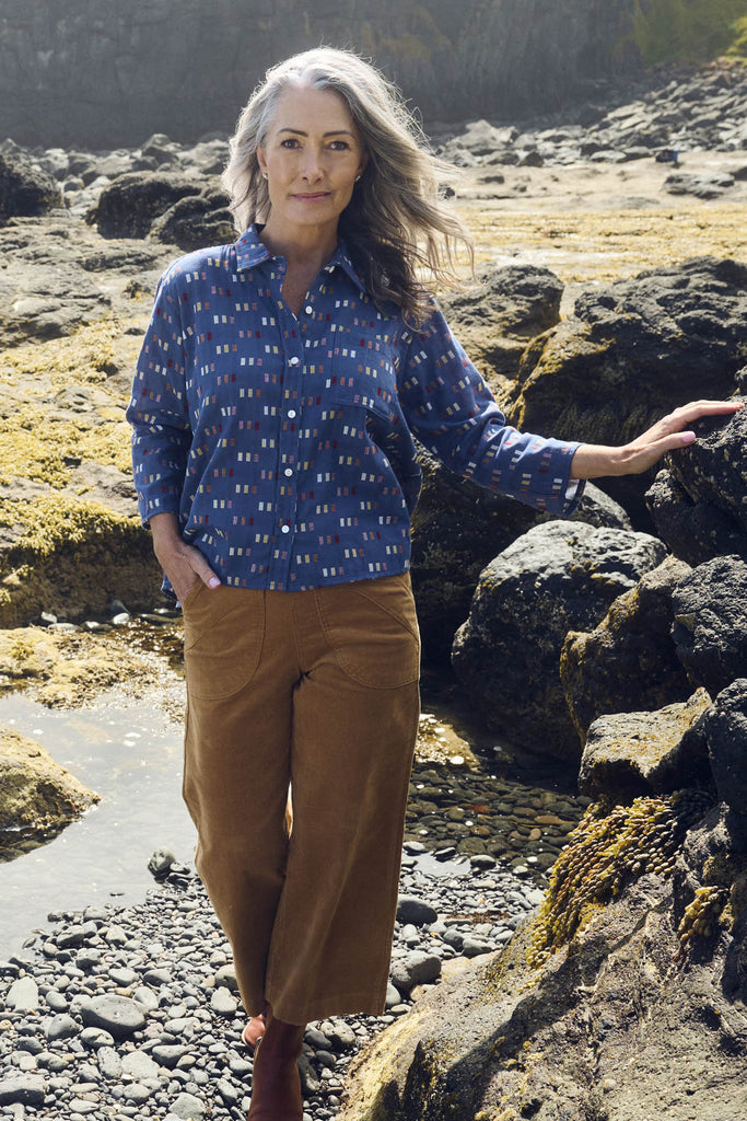 Olga de Polga classic shirt in the new Blue Telegraph woven cotton. With accents of red, yellow, cream and mauve. Front view on model