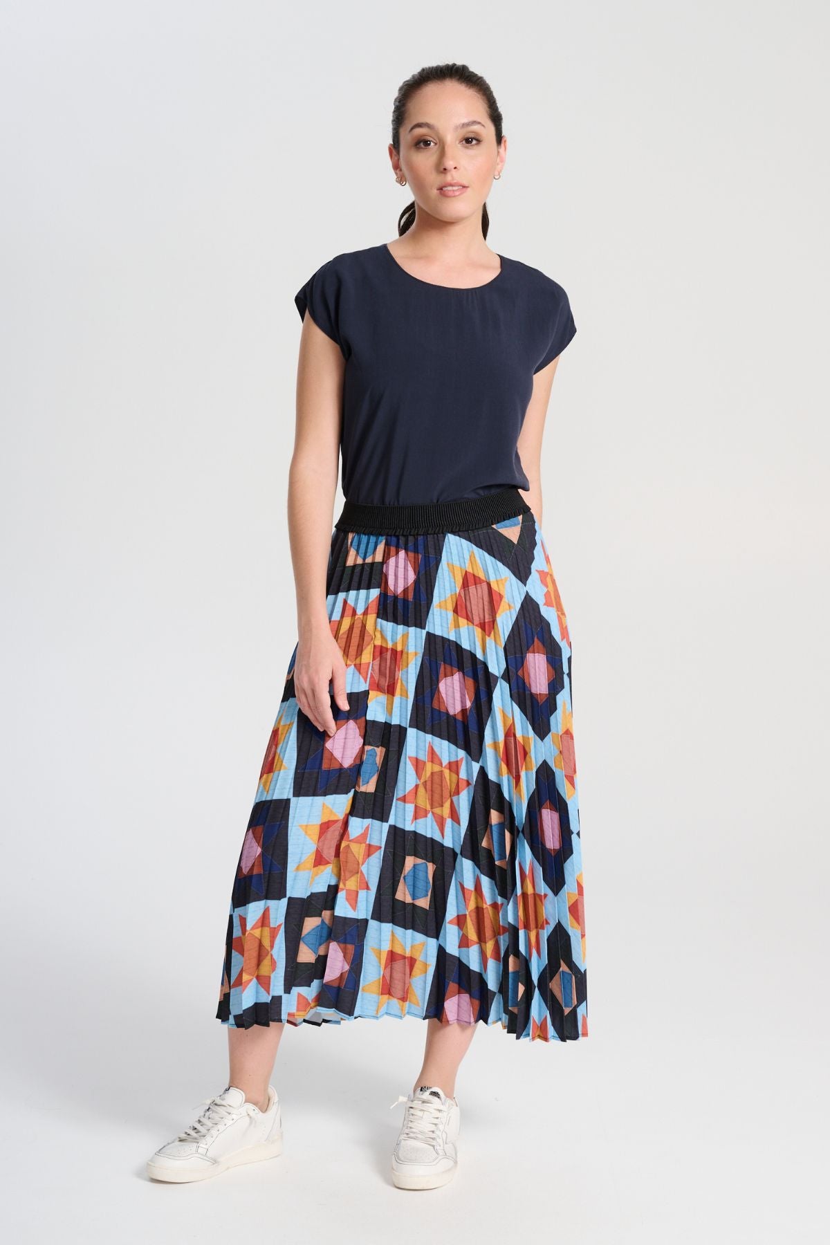 Olga de Polga printed pleated skirt in recycled polyester permanent pleats.  Fully elastic waistband.
Pull-on style.
A-line shape.
Midi length. Front view on model.