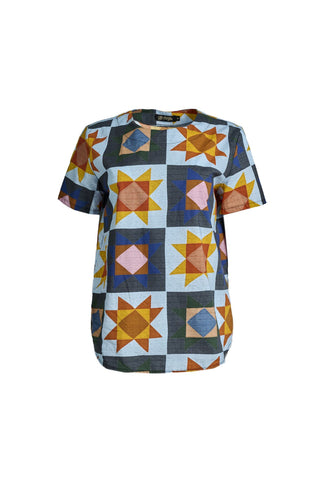 Olga de Polga Veda Day Top in printed cotton. Light blue background with geometric shapes. Round neckline, Short sleeves.  Front view