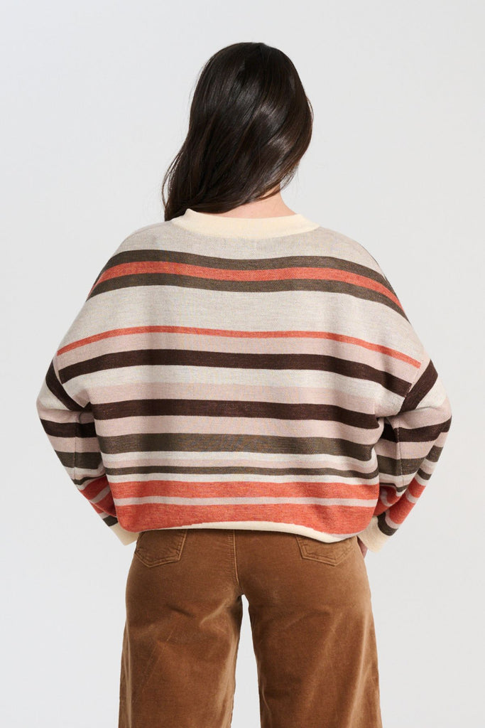 Olga de Polga Brown Earth Colorado Knit sweater with stripes in earthy colours of cream, coral, beige and brown. Long sleeves, dropped shoulders, round neckline. Back view on model