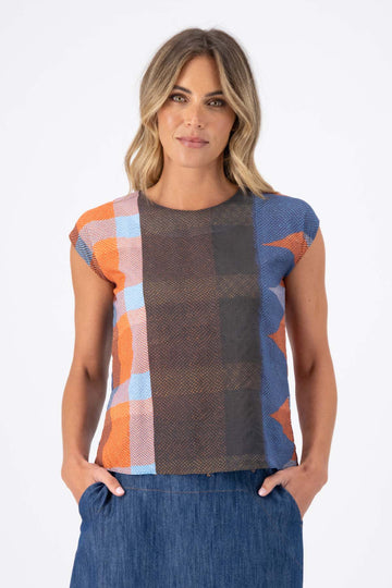 Olga de Polga Tee in Jada printed cotton seersucker. Shades of brown, red, pink and blue, and orange are all part of the Jada print. Front view on model.