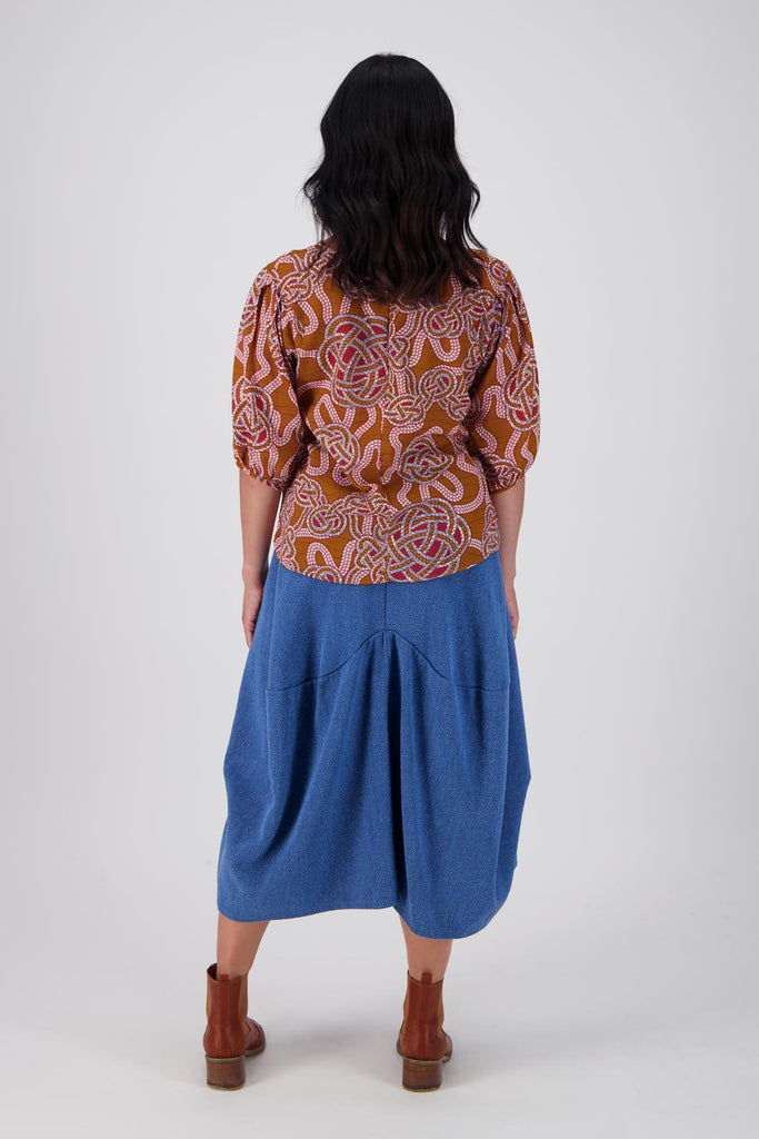 Olga de Polga seersucker blouse in the Love knots print with deep caramel brown and accents of blue and red. Wide boatneck neckline and back zip fastening. Full length back view