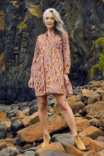 Olga de Polga new tunic dress in fine cotton cord.  In the love knots print. -More than just a print, "Love Knots" is a visual ode to the enduring power and beauty that emanate from the intertwined twists and turns of love's journey. Wear it as a heartfelt expression, a fashionable reminder of the meaningful ties that enrich your life. Front view on model