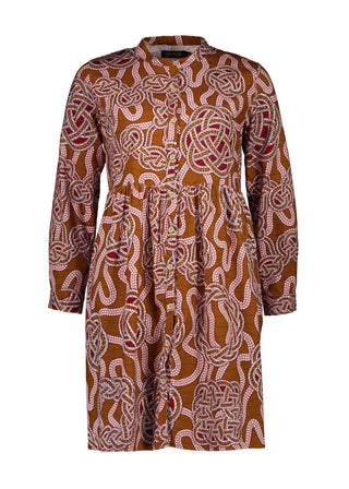 Olga de Polga new tunic dress in fine cotton cord. In the love knots print. -More than just a print, "Love Knots" is a visual ode to the enduring power and beauty that emanate from the intertwined twists and turns of love's journey. Wear it as a heartfelt expression, a fashionable reminder of the meaningful ties that enrich your life. Front view
